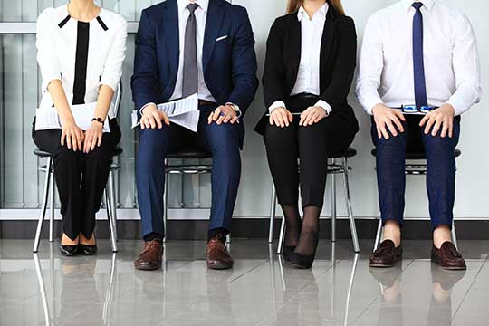 Four employees wait for an interview