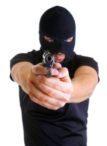 masked gunman aiming his firearm 