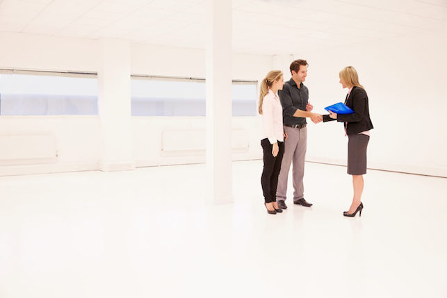 Estate Agent Shaking Hands With Clients Agreeing to Commercial Lease Agreement