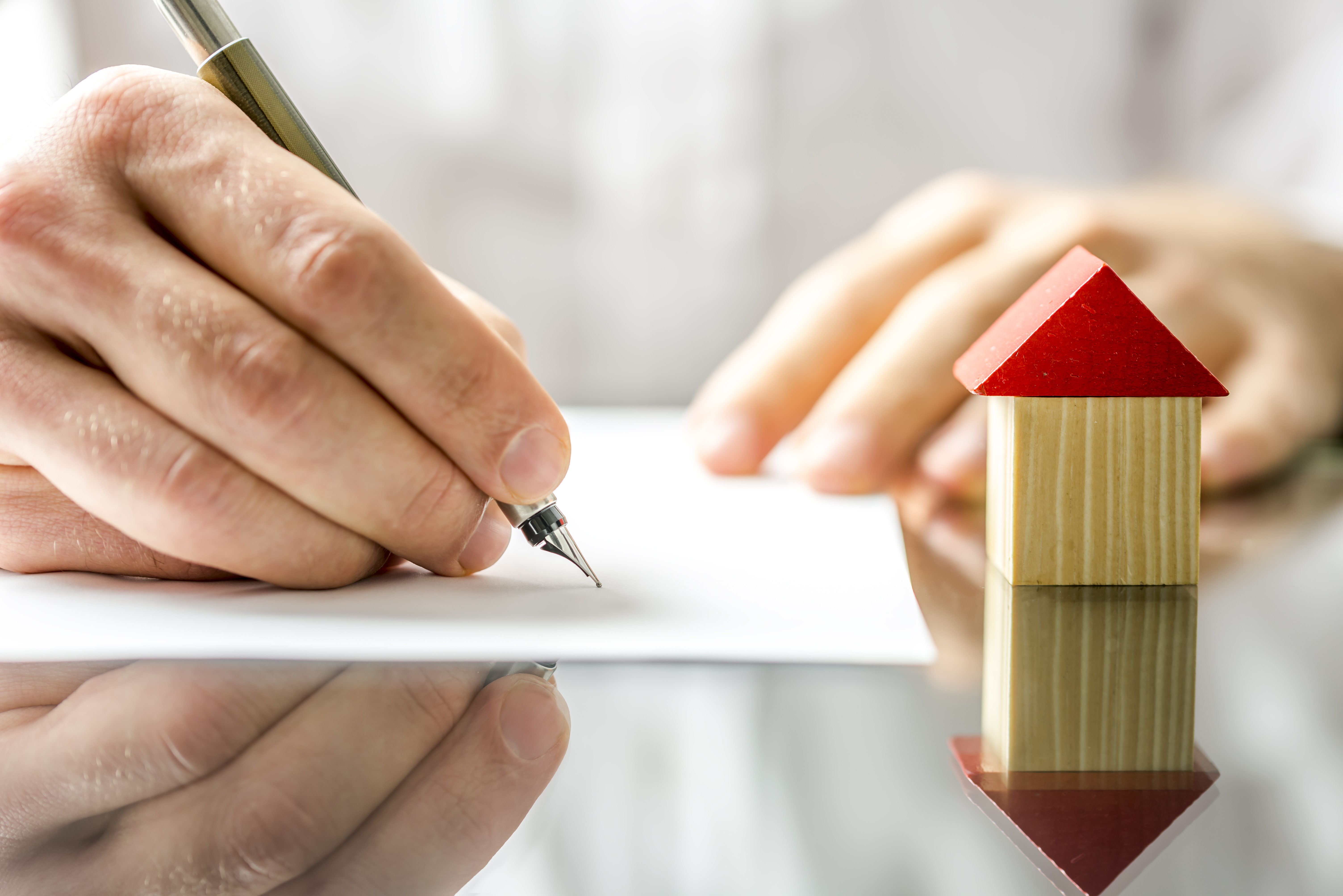 man signing quit deed when relinquishing rights to property