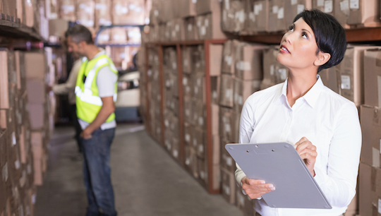Small business owner checks inventory in warehouse