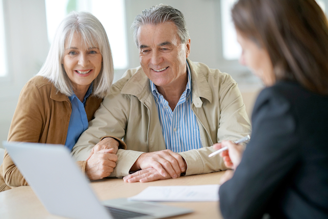 Senior couple meeting financial adviser about investing