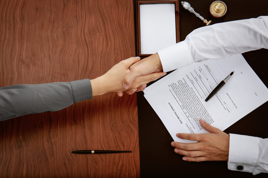 Woman and notary shake hands