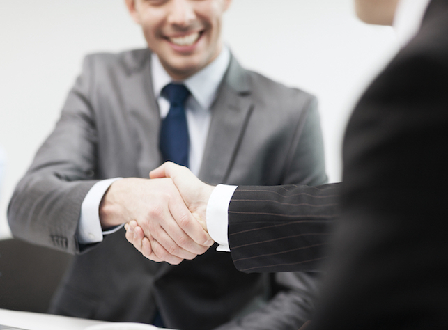 Boss and employee shake hands