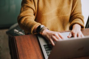 woman at laptop writing landlord reference letter