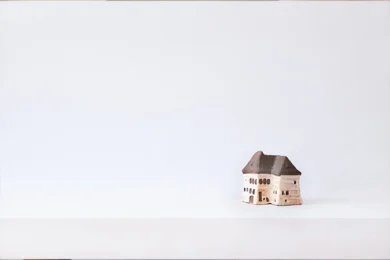 Brown Wooden House Miniature on White Surface