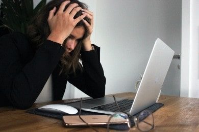Person stressed at laptop