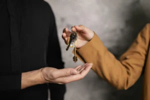 landlord giving keys to a tenant