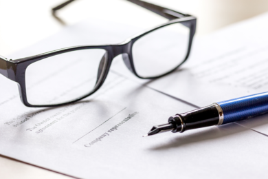 employment contract with pen and glasses