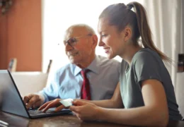 A daughter helps her aging father prepare a power of attorney form