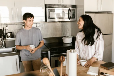 two roommates talking in a kitchen