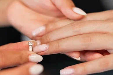 woman-putting-wedding-ring-on-another-woman's-finger